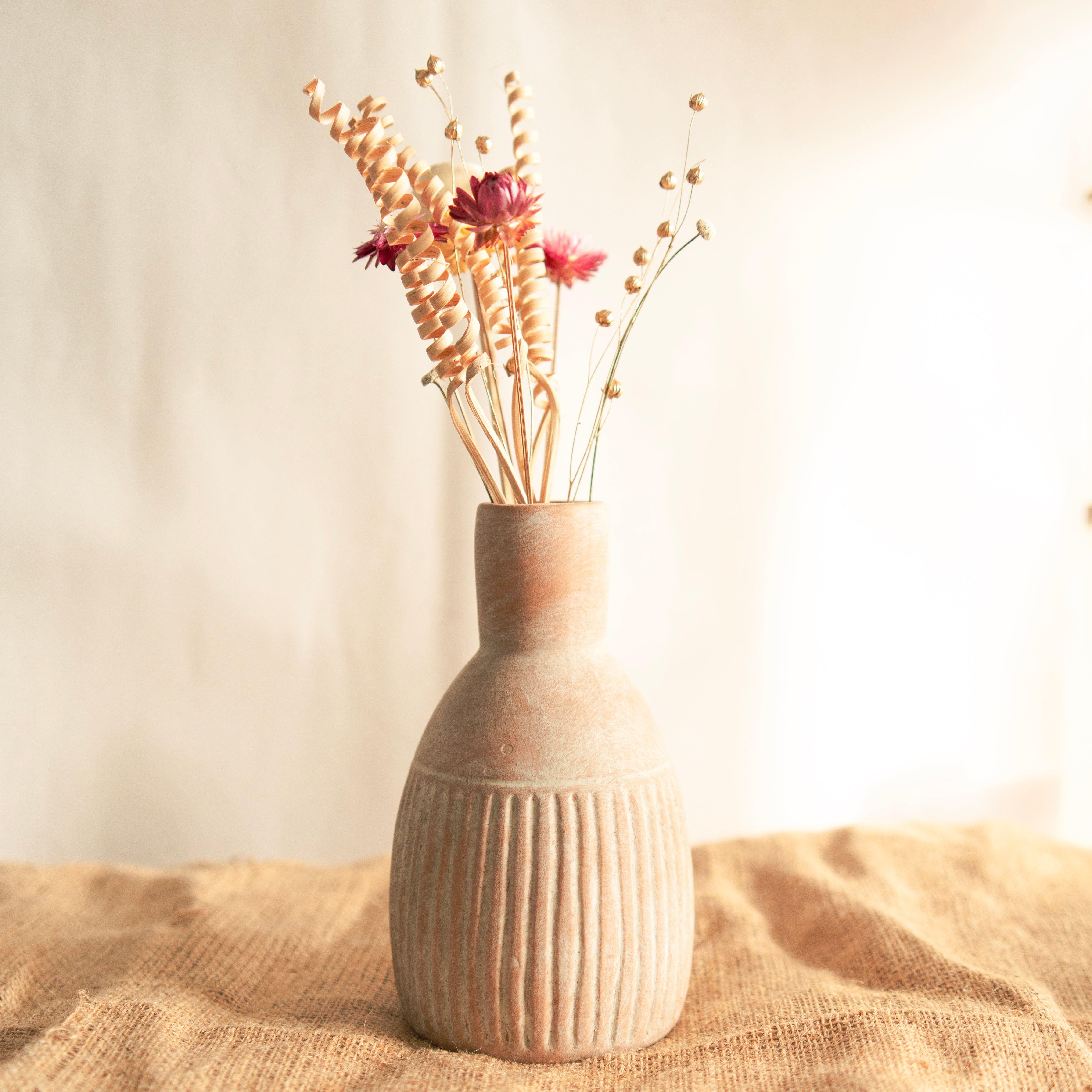 The Earthly vase with dried flower bunch
