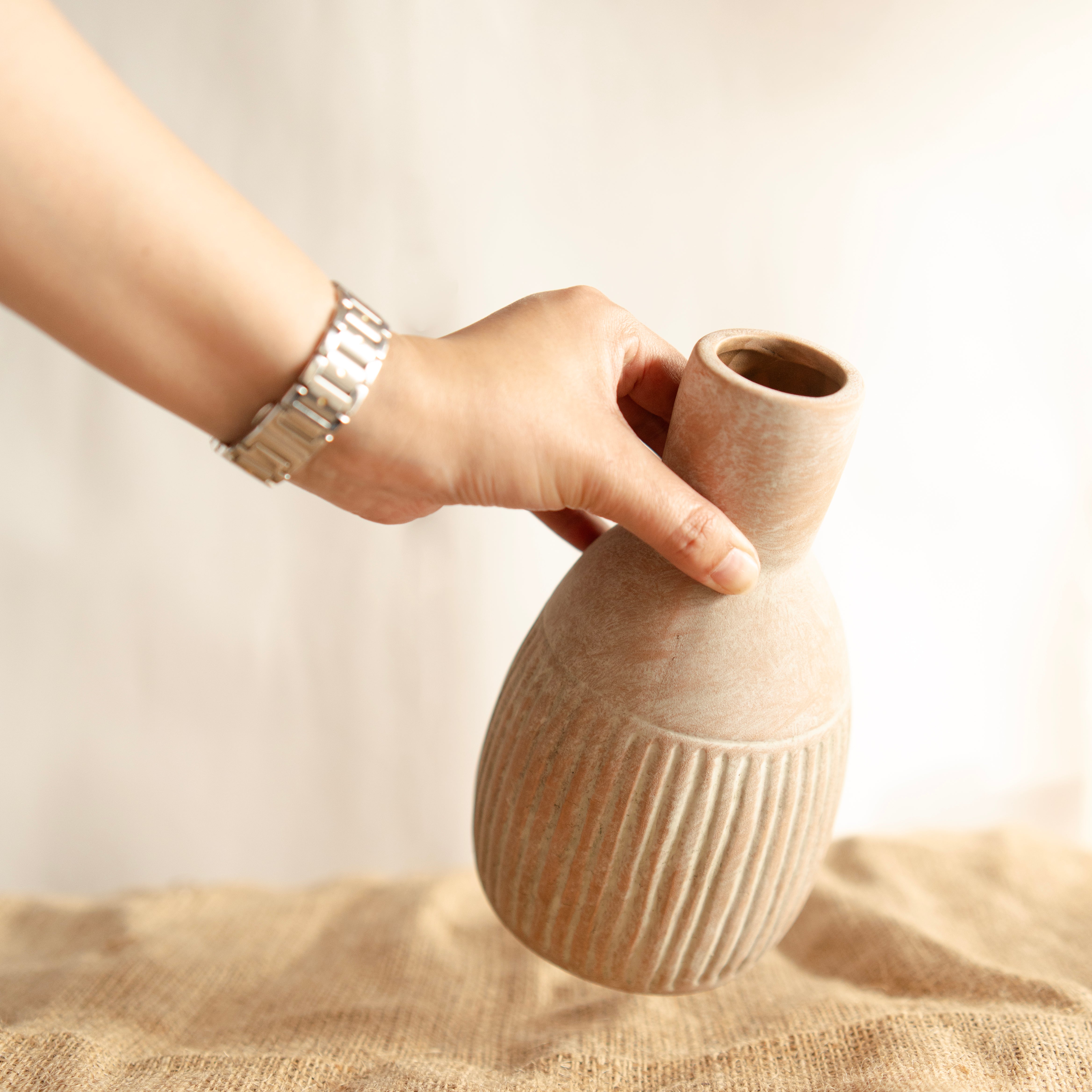 The Earthly vase with dried flower bunch
