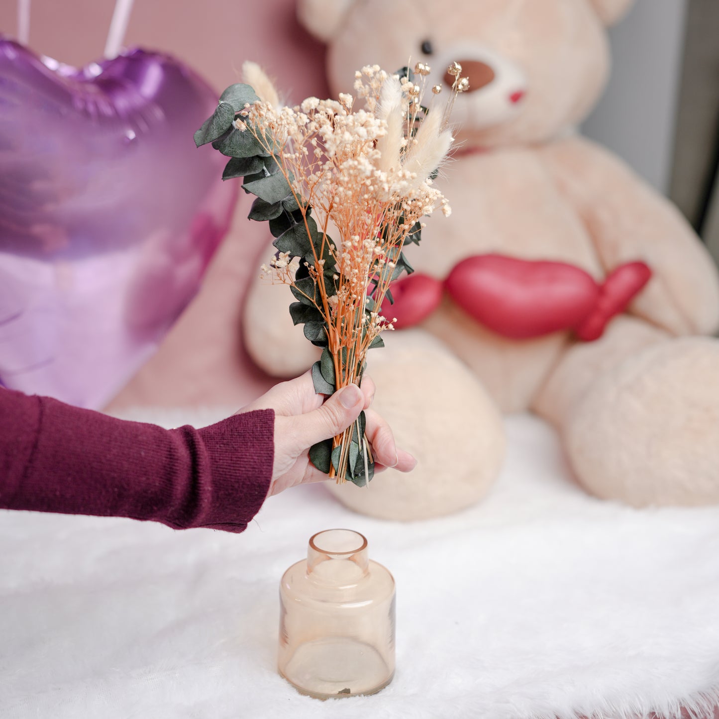 little blossom vase with dried flower bunch in mini glass vase