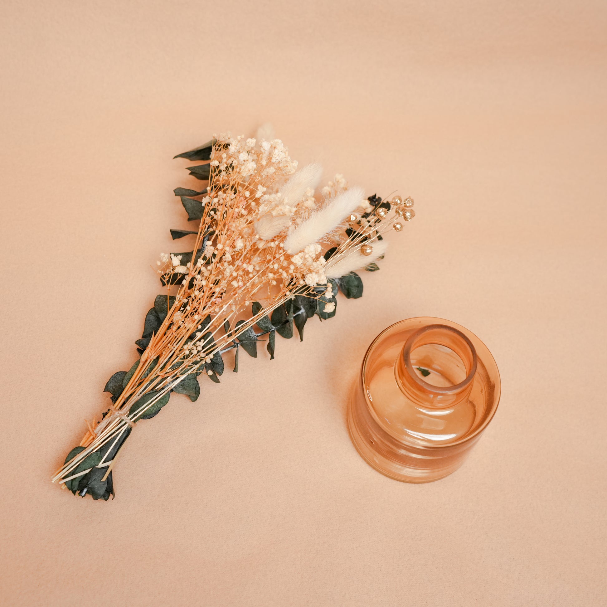 little blossom vase with dried flower bunch in mini glass vase