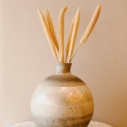 Aesthetic boho interior setup featuring dried bazar sticks in a vase for modern rustic home decoration