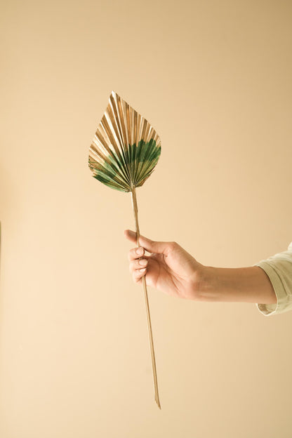 Boho style golden green dual tone palm leaves used as rustic decorative elements in modern interior space