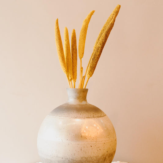 Yellow dried bazar sticks arranged in a vase for vibrant and aesthetic home decor styling